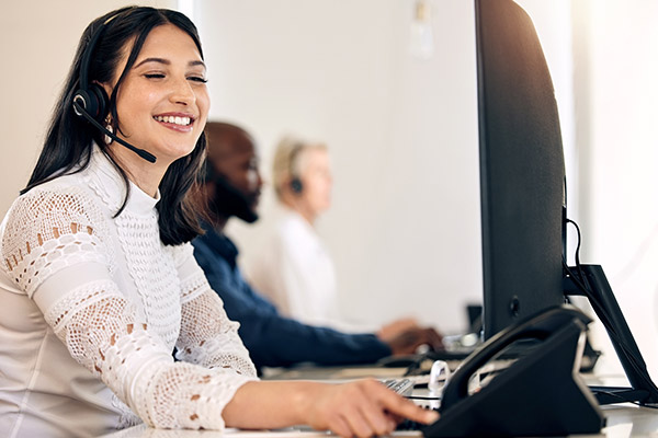 VoIP Phones – Headphones Picture of female using headset and phone